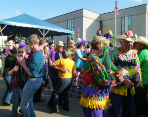 On Mardi Gras afternoon,, a crowd of locals and visitors dance to the music of Steve Riley and the Mamou Playboys.