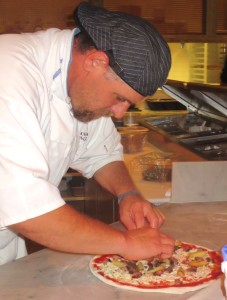 Chef Andrea creating a pizza masterpiece.